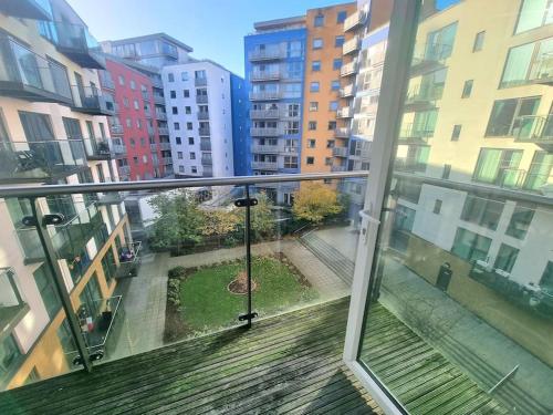 a balcony with a view of a city with buildings at 2Bed 2Bath -Pool, Balcony, Gym Lift in London