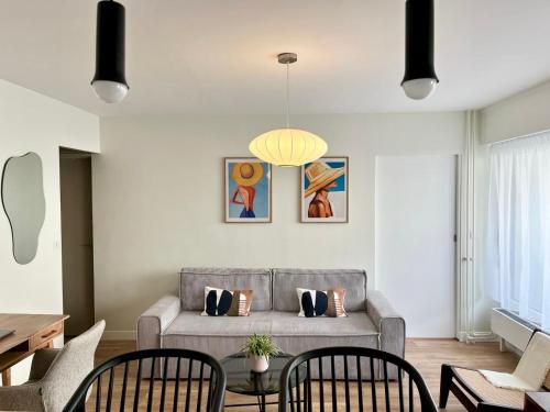 uma sala de estar com um sofá e uma mesa em Le Silly - Bel appartement - Paris & Parc des Princes em Boulogne-Billancourt