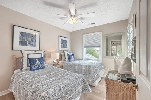 a bedroom with two beds and a ceiling fan at New Listing! Pelican Bay 14 -Luxury Home at Beach! in Isle of Palms