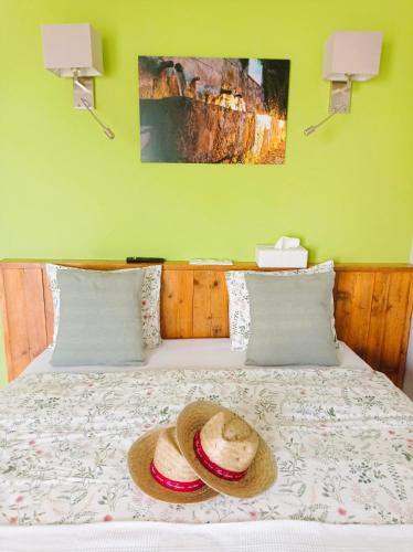 a bedroom with a bed with a hat on it at Casa Lennisa in La Vall de Laguar