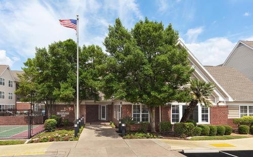 une maison arborant un drapeau américain devant elle dans l'établissement Residence Inn by Marriott Austin Round Rock/Dell Way, à Round Rock