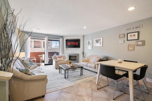 a living room with a couch and a table at IB Coastal Condo - Imperial Beach - Shops - Patio in Imperial Beach
