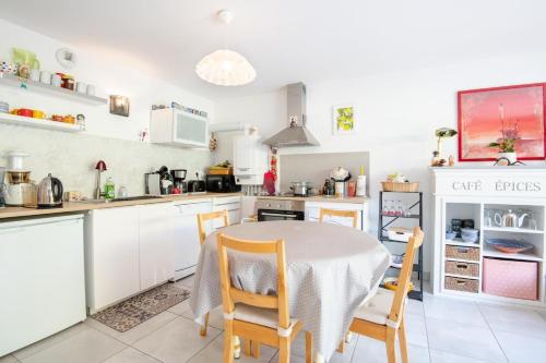 a kitchen with a table and chairs in a kitchen at Peace and quiet in the heart of the city in Tours