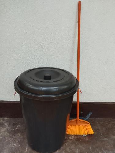 a broom and a black bucket with a broom at Serene Bliss Villa in Unawatuna