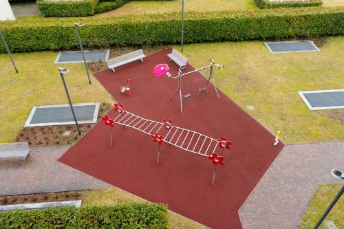 an aerial view of a playground with swings and benches at 5min RhoFiera-10minMetro-Parking in Pero