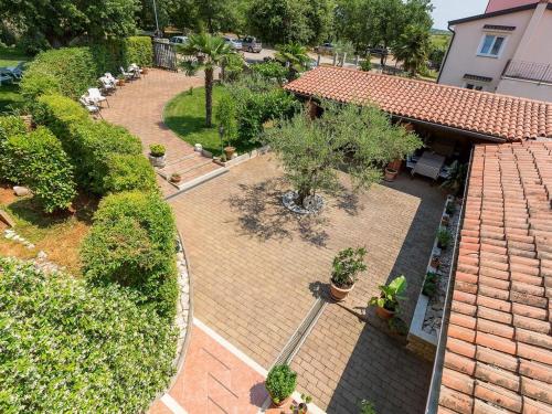 an overhead view of a courtyard with trees and plants at Bed and Breakfast Kolo Adults only in Novigrad Istria