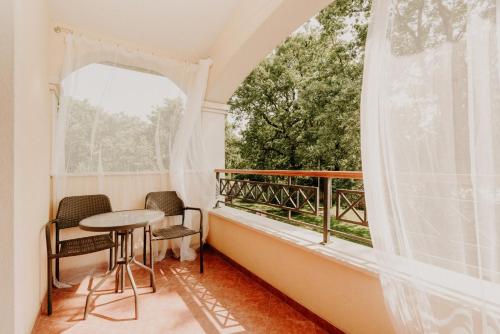 a balcony with a table and chairs and a window at Bed and Breakfast Kolo Adults only in Novigrad Istria