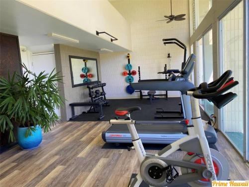a gym with a treadmill and a exercise bike at Beautiful Condo Right on the Beach in Hauula