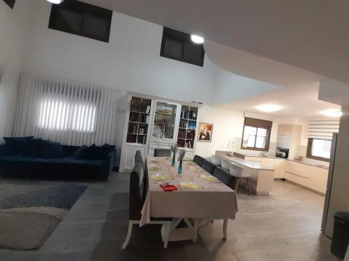 a living room with a table and a couch at Diamond in Beit Shemesh