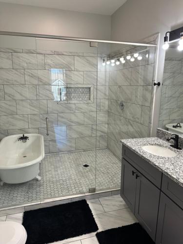a bathroom with a shower and a toilet and a sink at Decatur Delight Mixed- Use Apartments! in Decatur