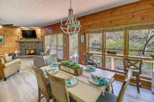 a dining room and living room with a table and chairs at Riverfront Home w Gameroom & Screened Porch in Ellijay