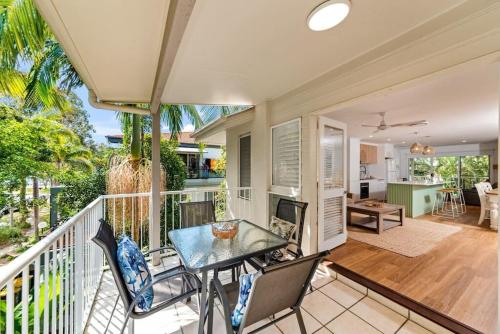 a porch with a table and chairs on a balcony at Large Noosaville Gem - Off Gympie Terrace in Noosaville