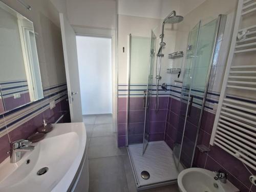uma casa de banho com um lavatório, um chuveiro e um WC. em La Prora em Civitanova Marche
