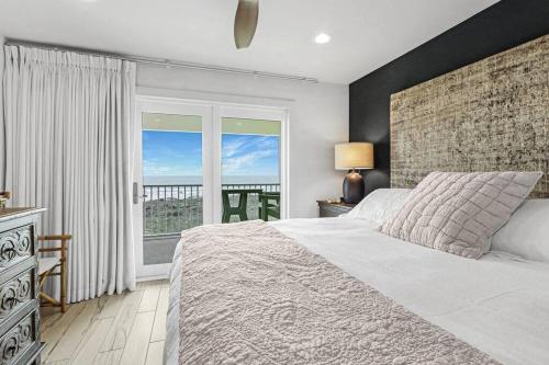 a bedroom with a large bed and a large window at Grand Caribbean 4007 in Port Aransas