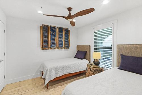 a bedroom with two beds and a ceiling fan at Grand Caribbean 4007 in Port Aransas