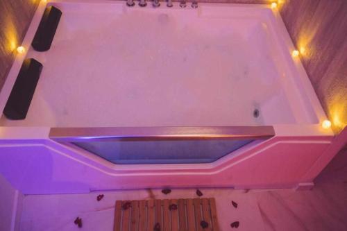 a pink bath tub with lights on top of it at LOFT TÚ y YO in Alcalá del Júcar