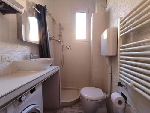 a bathroom with a sink and a toilet at Suite Del Parco in Bologna