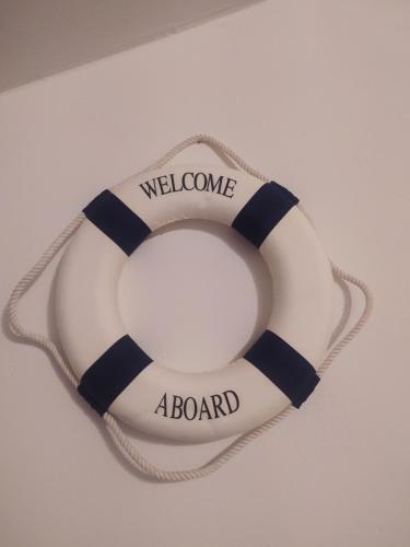 a life buoy with the words welcome a board on it at Il Giramondo in Montelabbate
