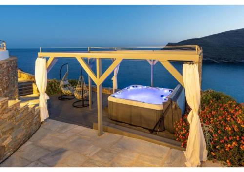 a gazebo with a bed on a patio at Blueros - Olive suite in Megas Yialos-Nites