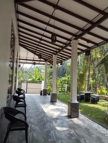 a pavilion with chairs and tables on a patio at Serene Bliss Villa in Unawatuna