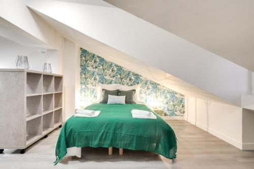 - une chambre avec un lit et une couverture verte dans l'établissement 805 Suite Amazing - Superbe Duplex, à Bagnolet