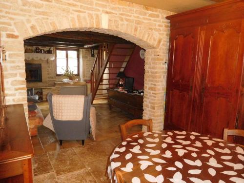 a living room with a room with a brick wall at Gîte Cusey, 3 pièces, 4 personnes - FR-1-611-5 in Cusey