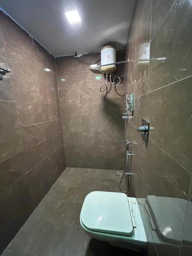 a bathroom with a shower with a toilet in it at The Elite Beachview in Puducherry