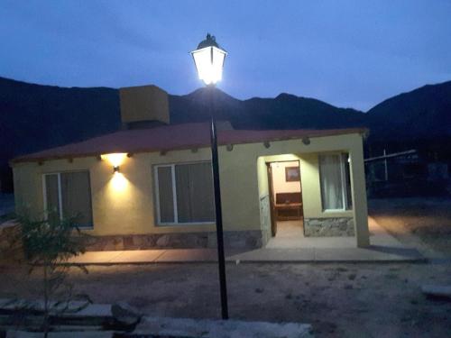 a street light in front of a house at night at 4 ELEMENTOS in Huacalera