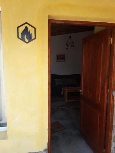 an open door to a room with a yellow wall at 4 ELEMENTOS in Huacalera