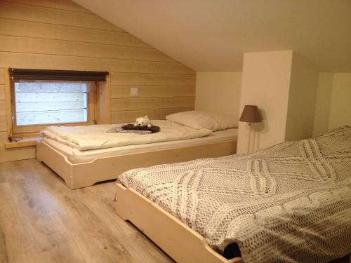 a bedroom with two beds and a window at Maison lumineuse avec sauna, terrasse sud, proche Gérardmer, animaux acceptés - FR-1-589-369 in Gérardmer