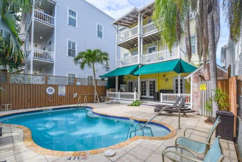 a swimming pool in front of a building at Curry House - Pool, King Bed & Balcony! Room 7 in Key West