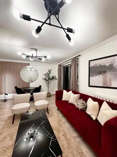a living room with a red couch and a table at Luxury Apartment in Central London - 24 7 Security in London