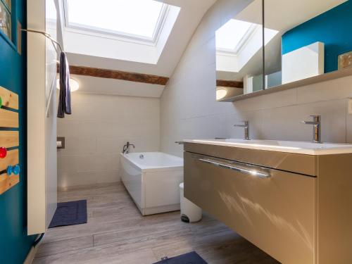 a bathroom with a sink and a bath tub at Maison de charme à la campagne avec terrasse et grand espace extérieur - FR-1-585-76 in Bazeilles-sur-Othain