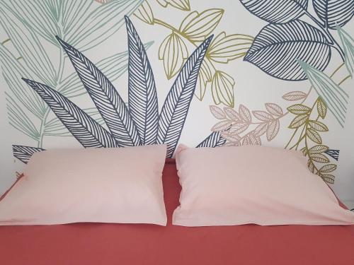 a pillow sitting next to a wall with a mural at Gîte élégant en pleine nature avec terrasse, départ randonnées, parking privé et équipements inclus - FR-1-589-384 in Le Tholy