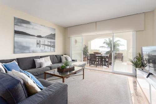 a living room with a couch and a table at Charming Marbella in Marbella