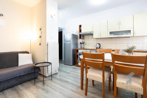 a kitchen and living room with a table and a couch at Apartment May in Split
