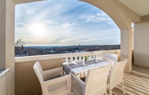 a dining room with a table and chairs on a balcony at Beautiful Home In Slivnica With Wifi in Slivnica