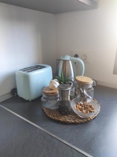 a counter with a toaster and a basket of food at L'AUNISA in El Campello