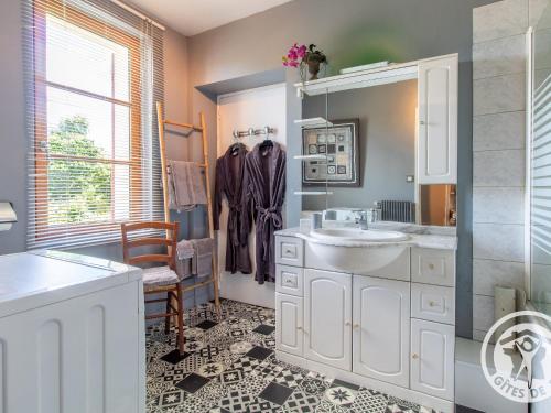 a white bathroom with a sink and a mirror at Gîte Savennières, 2 pièces, 2 personnes - FR-1-622-18 in Savennières