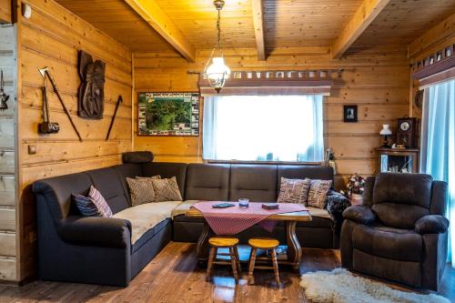 a living room with a couch and a table at Chalupa Lenka in Vysoké Tatry