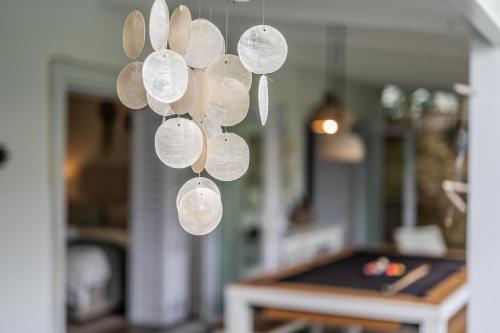 a bunch of glass disks hanging from a ceiling at Luxury Private Beach Villa centrally located. in Westbrook