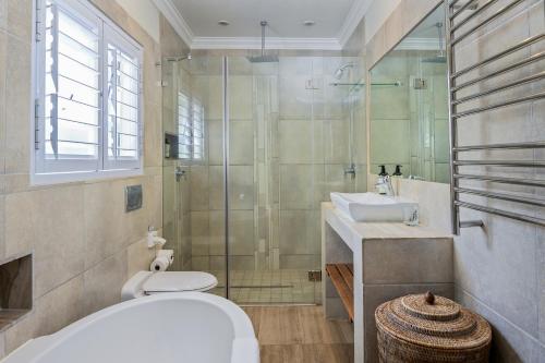 a bathroom with a shower and a toilet and a sink at Luxury Private Beach Villa centrally located. in Westbrook