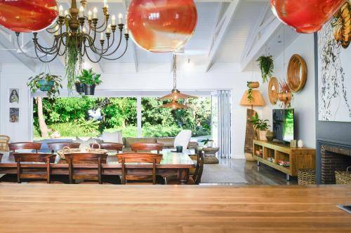 a dining room with a table and a couch at Luxury Private Beach Villa centrally located. in Westbrook