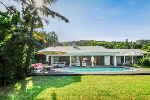 a house with a swimming pool in a yard at Luxury Private Beach Villa centrally located. in Westbrook