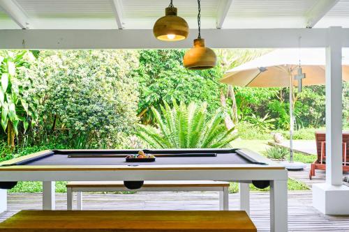 a pool table sitting on a deck with a pool table at Luxury Private Beach Villa centrally located. in Westbrook