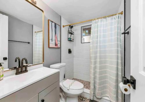 a bathroom with a sink and a toilet and a shower at Stunning 1 BD 1BA In Naples in Naples