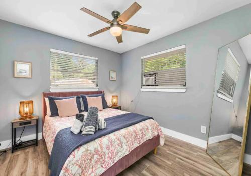 a bedroom with a bed and a ceiling fan at Stunning 1 BD 1BA In Naples in Naples