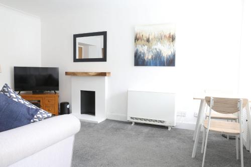 a living room with a couch and a tv at Bank Place in Crieff