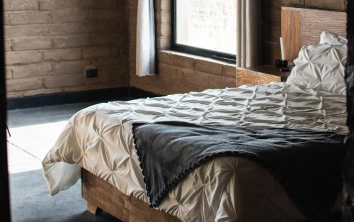 a large bed in a room with a window at Naakary Home in San Miguel de Allende