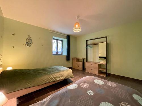 een slaapkamer met een bed en een spiegel bij Gîte Cistrières, 3 pièces, 4 personnes - FR-1-582-345 